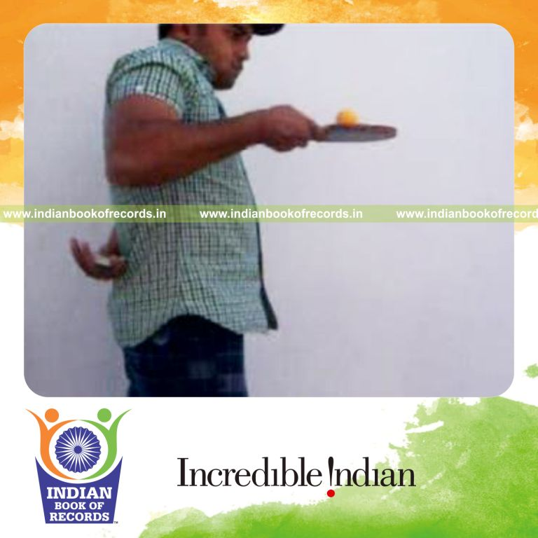 individual performing revolution 2 and three packet thumb cuts behind back while bouncing table tennis ball for record in Indian Book of Records