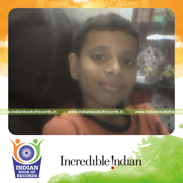 young boy solving rubiks cube while singing national anthem for Indian Book of Records