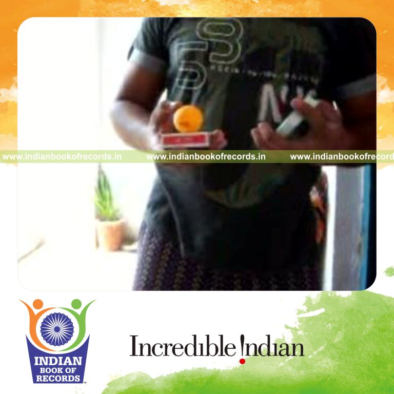individual performing sabers flipper card cut while bouncing ball on deck for record in Indian Book of Records