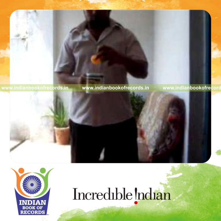 individual performing sabers flipper card cut while bouncing ball on coffee mug for record in Indian Book of Records