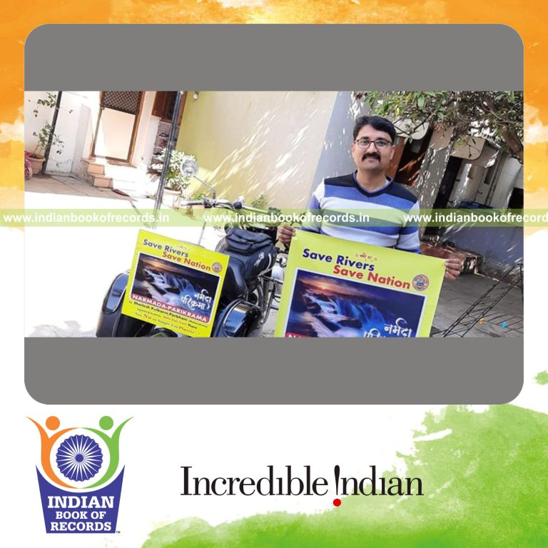 an individual completing the fastest solo bike ride around the narmada river for a record in Indian Book of Records