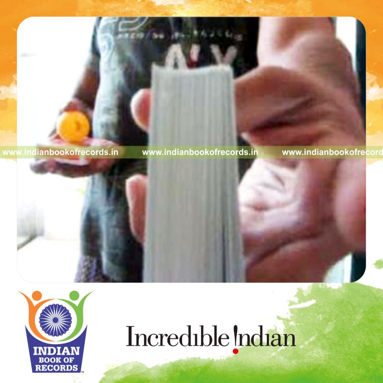 individual performing three packet thumb cut while bouncing ball on deck for record in Indian Book of Records