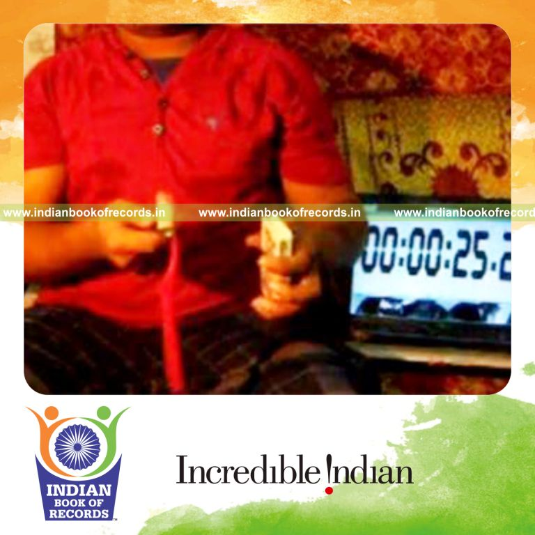 individual performing thumb card cut while spinning toothbrush on pen for record in Indian Book of Records