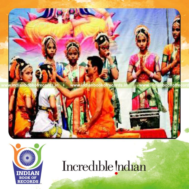 male individual performing makeup for 100 classical dancers quickly for record in Indian Book of Records