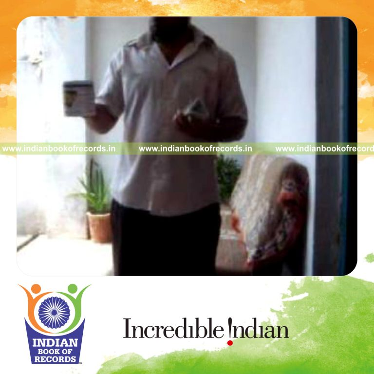 individual performing triangle card cut while bouncing ball on coffee mug for record in Indian Book of Records