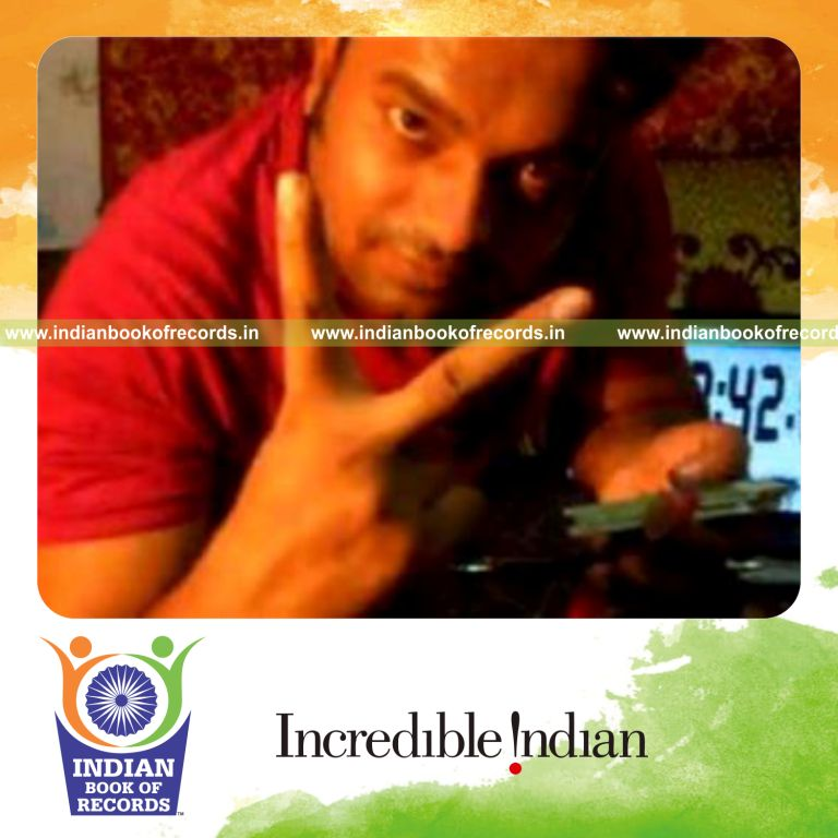 individual performing triple charlier card cut while spinning toothbrush on pen for record in Indian Book of Records