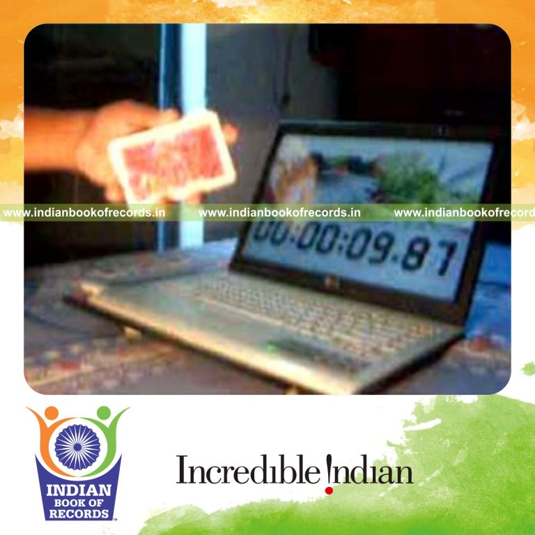 individual performing fastest two handed reverse scissor card cut for record in Indian Book of Records