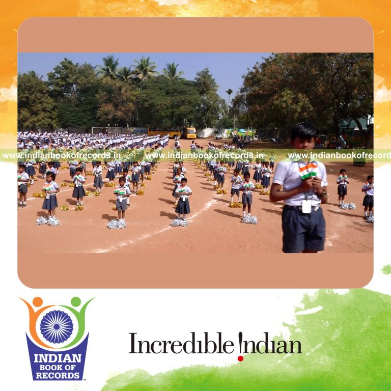 participants performing sports drill with flags for Indian Book of Records
