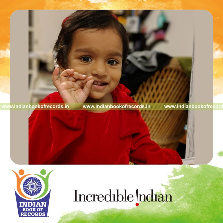 Toddler identifying various objects from flash cards in a learning activity recognized by Indian Book of Records