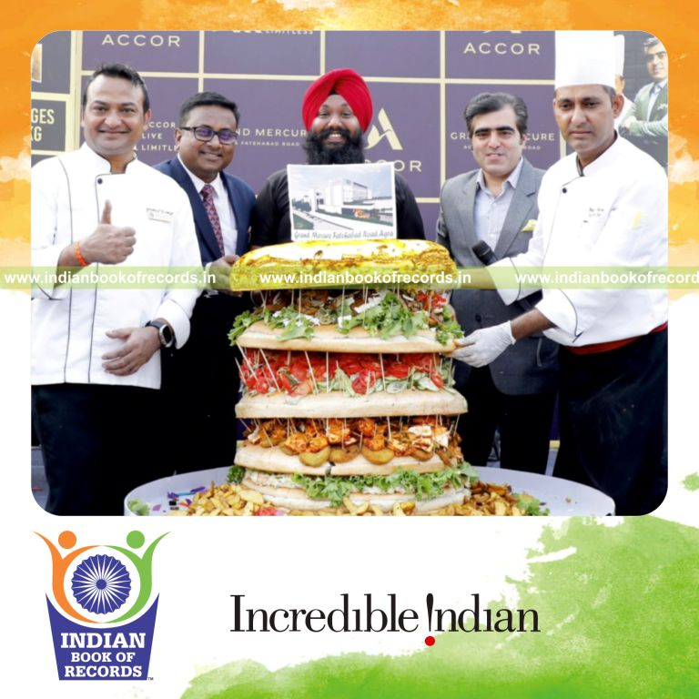 Large burger layered with gold leaf prepared as a heavy culinary creation recognized by Indian Book of Records