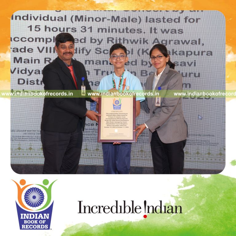 Young musician playing guitar in an extended performance session recognized by Indian Book of Records