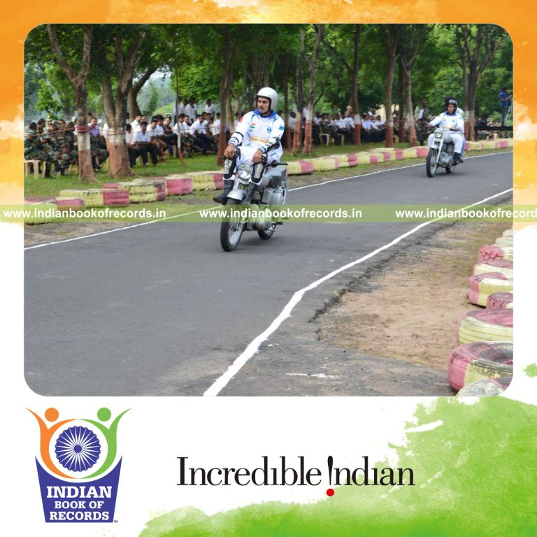 individual sitting on handlebar while riding motorcycle for Indian Book of Records