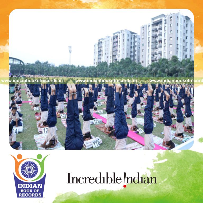 participants performing headstands together at a single venue as part of a record attempt for Indian Book of Records