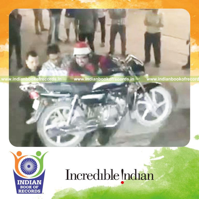 individual carrying heaviest motorcycle up and down staircase for record in Indian Book of Records