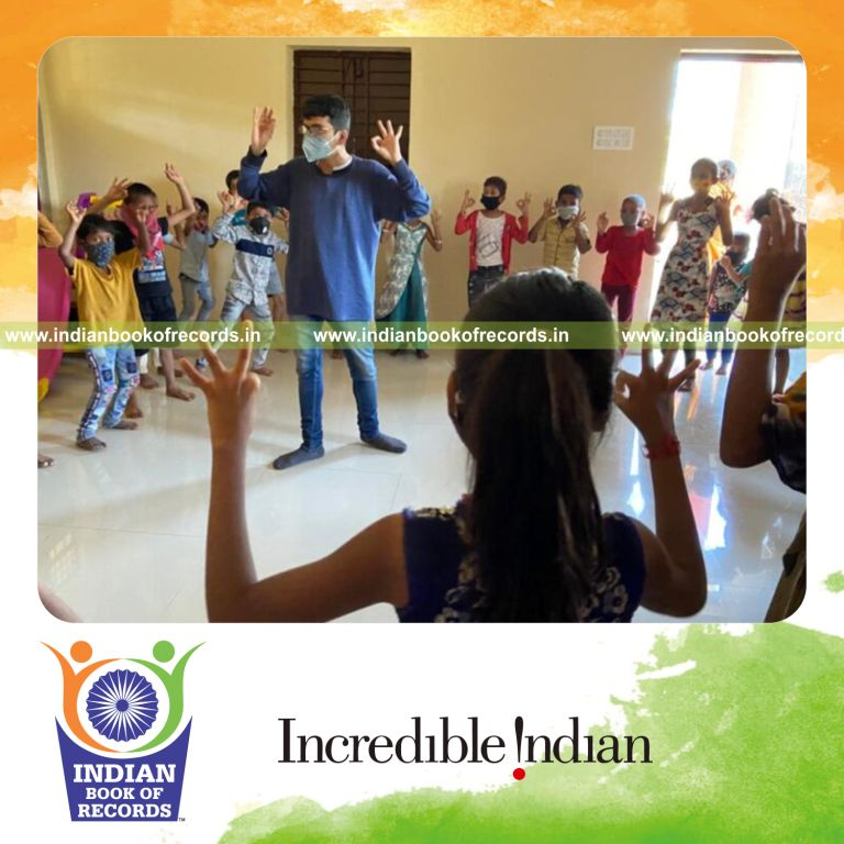 Participants dancing together to devotional songs in a large gathering recognized by Indian Book of Records