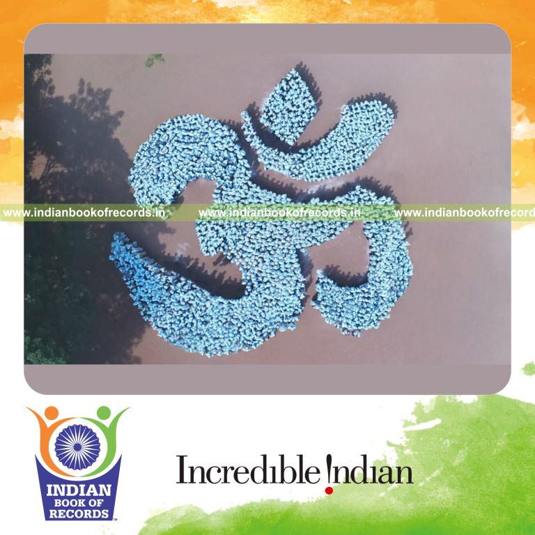 people forming a large human om symbol during a coordinated record attempt for Indian Book of Records