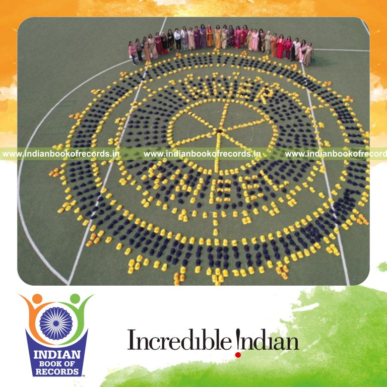 Large logo of Inner Wheel Club formed using numerous colored caps arranged precisely recognized by Indian Book of Records