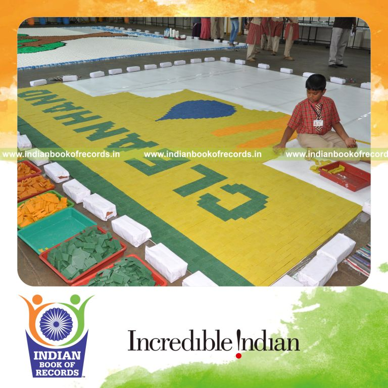 male individual creating large mosaic using bath soaps for record in Indian Book of Records