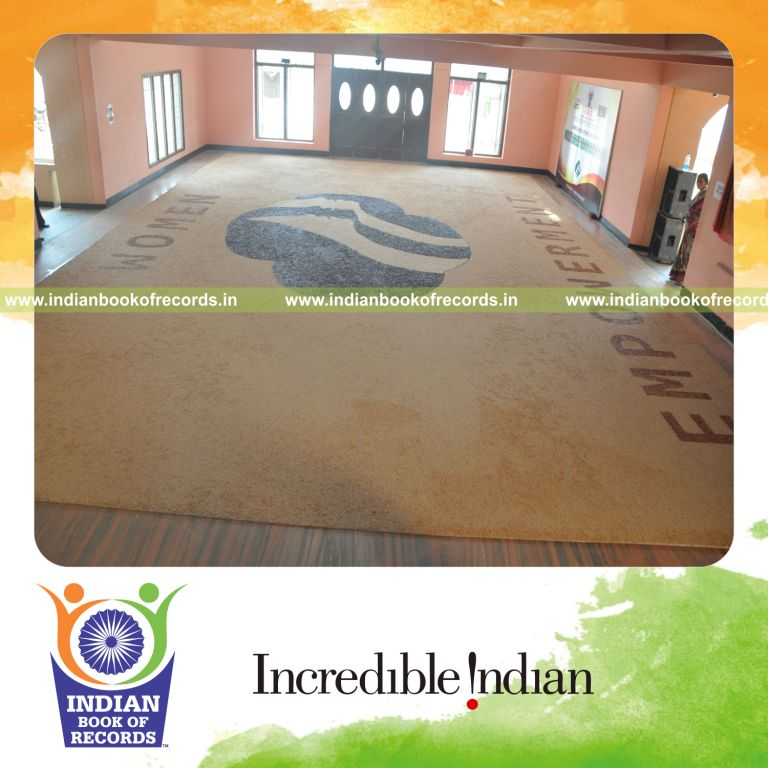 team creating large mosaic artwork using beans for record in an Indian Book of Records