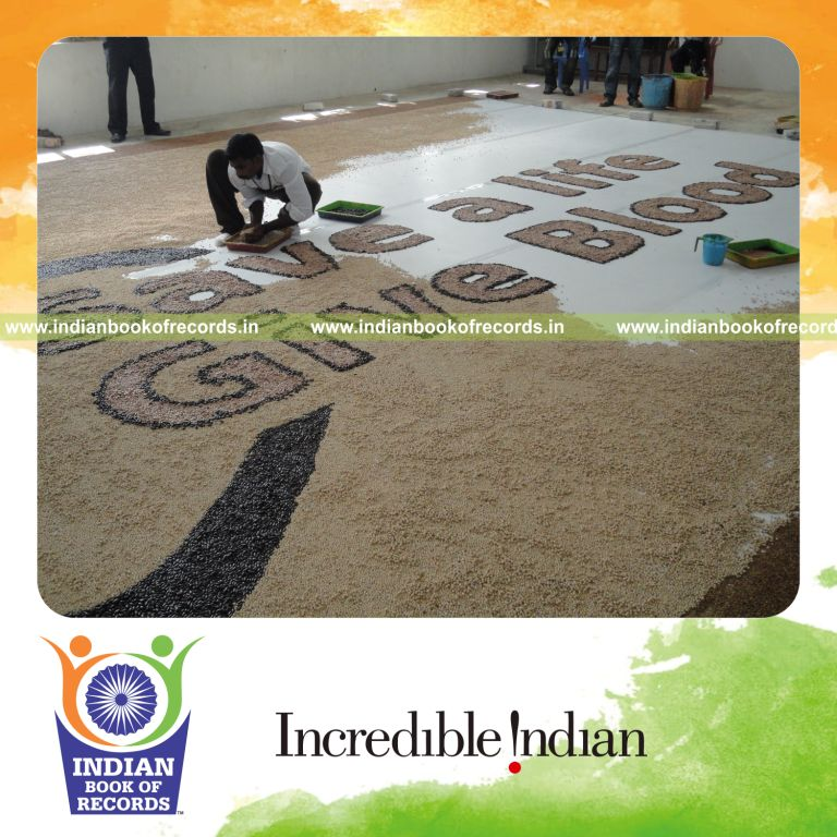 male individual creating large mosaic artwork using beans for record in Indian Book of Records