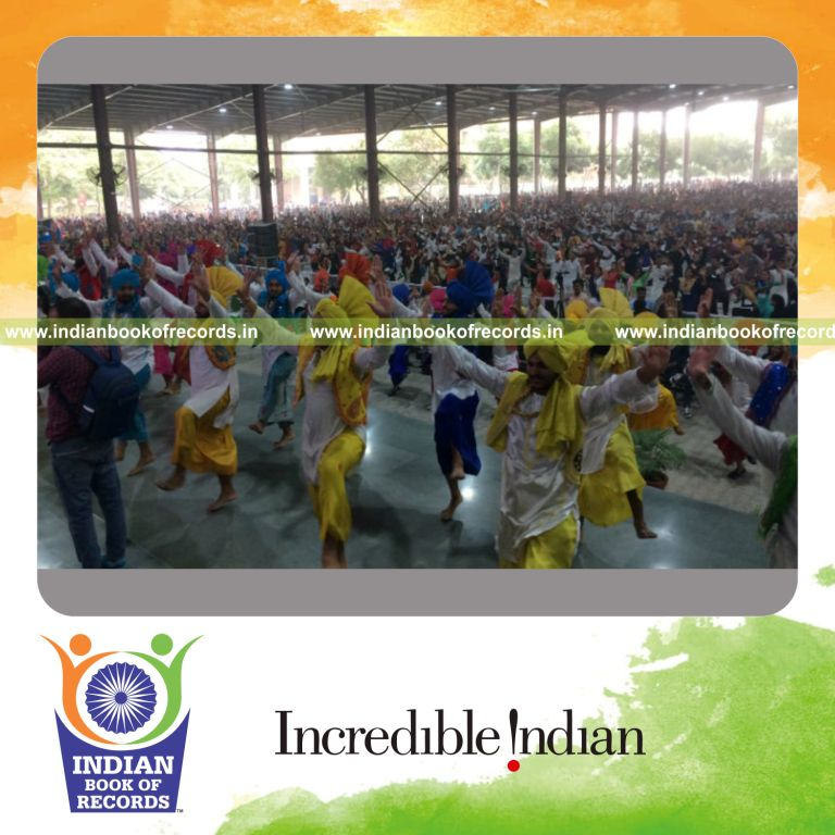 a large group performing bhangra dance together in a synchronized cultural event for a record in Indian Book of Records