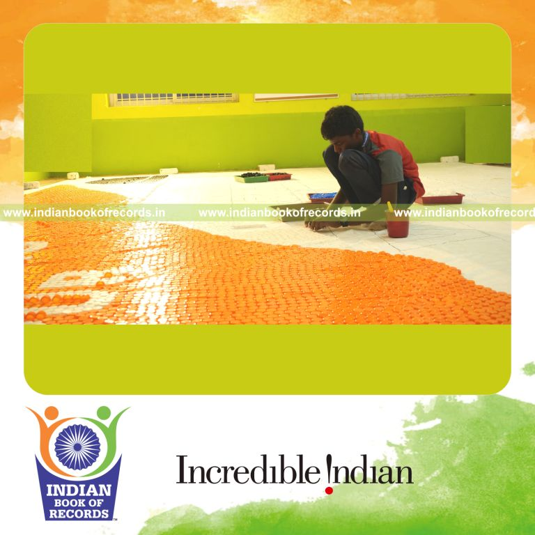 Creative mosaic made from numerous bottle caps arranged into a large design for Indian Book of Records
