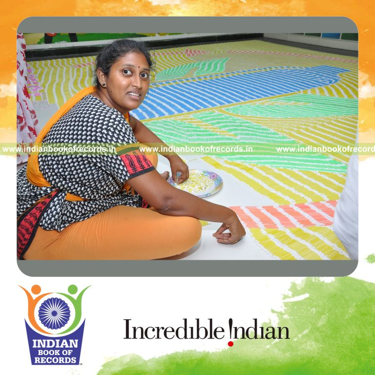 female individual creating large mosaic using buds for record in Indian Book of Records