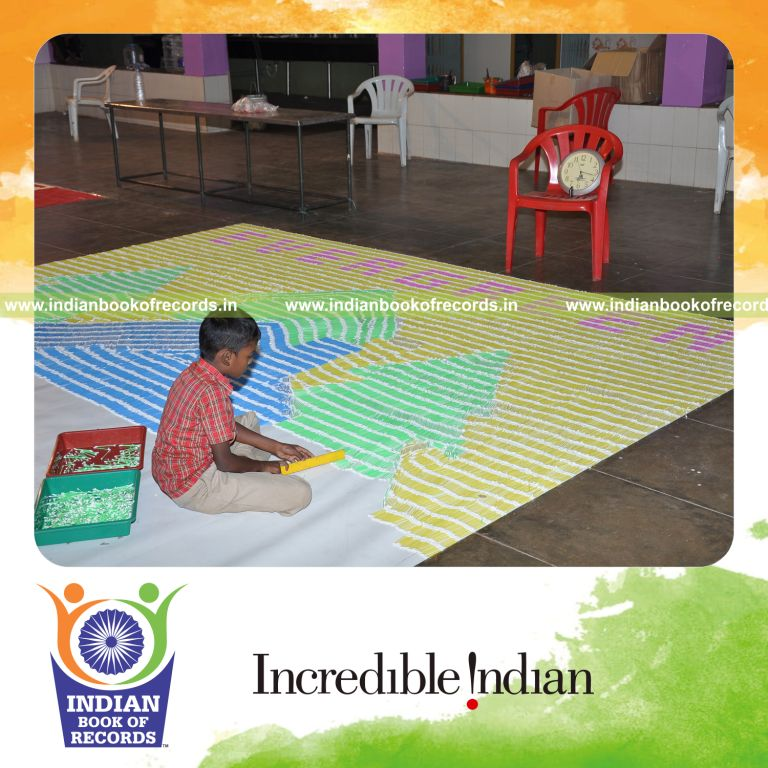 male individual creating large mosaic using buds for record in Indian Book of Records