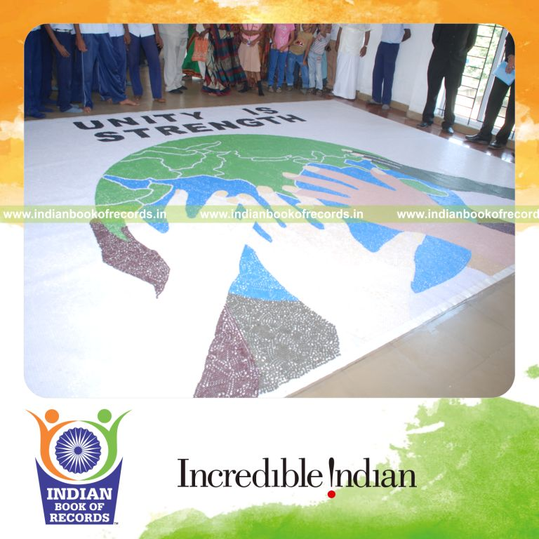 male individual creating large mosaic using buttons for record in Indian Book of Records