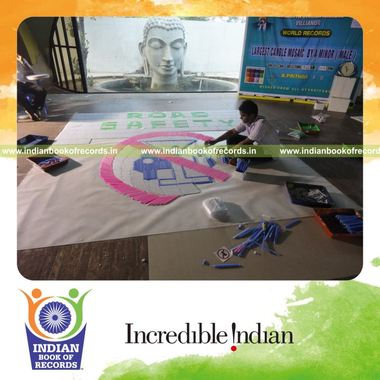 young male creating large mosaic using candles for record in Indian Book of Records