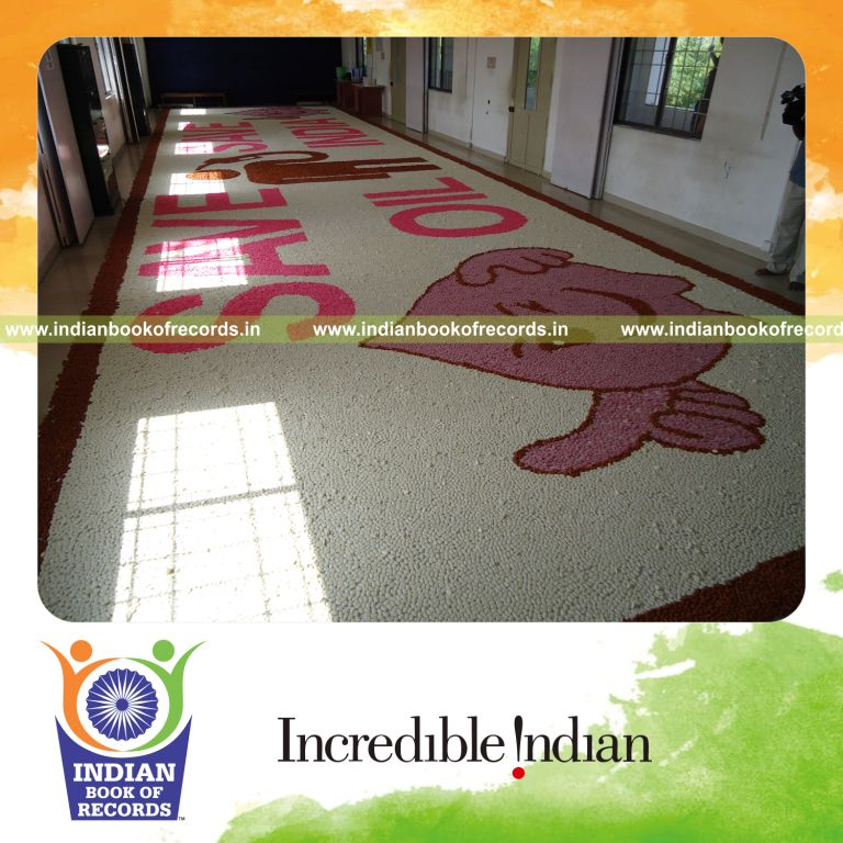 young female creating large candy mosaic artwork for record in Indian Book of Records