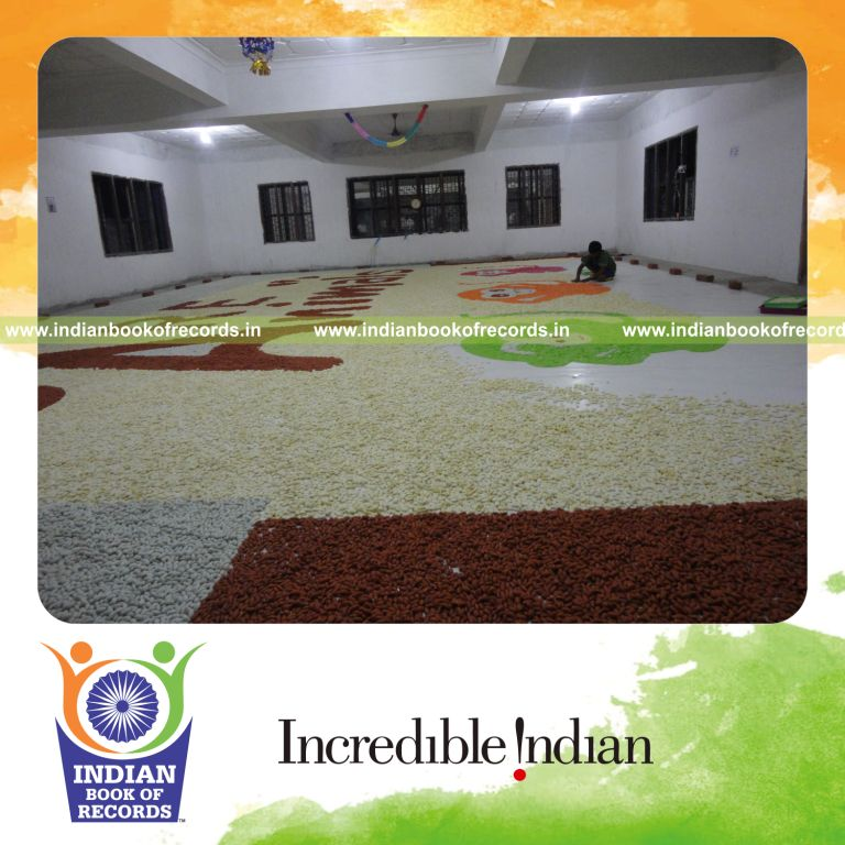 male individual creating large candy mosaic artwork for record in Indian Book of Records