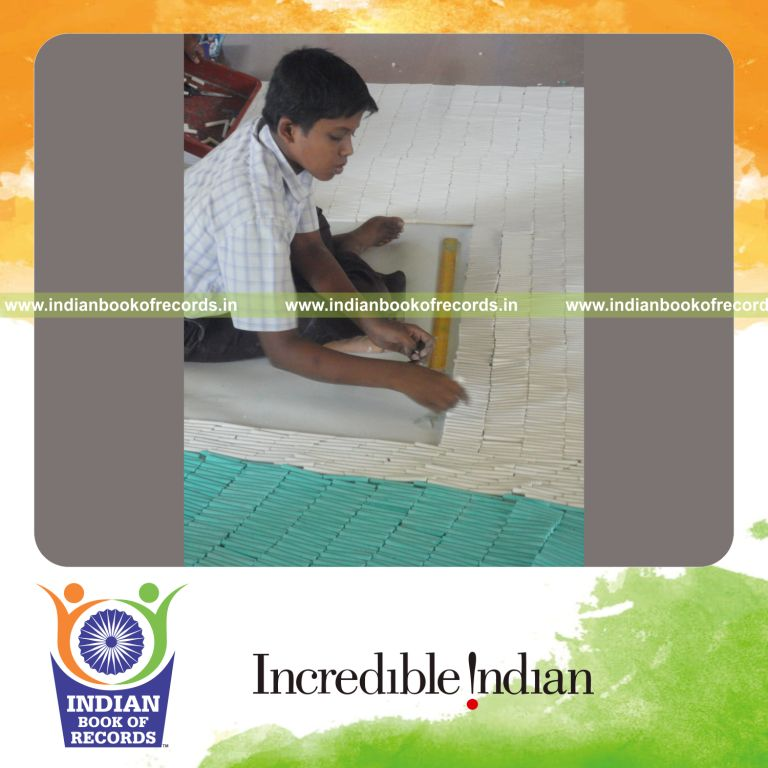young male creating large mosaic using chalk for record in Indian Book of Records