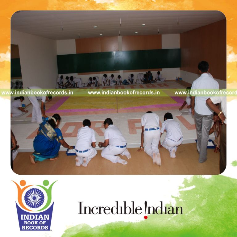 team creating large mosaic using chalk pieces for record in Indian Book of Records