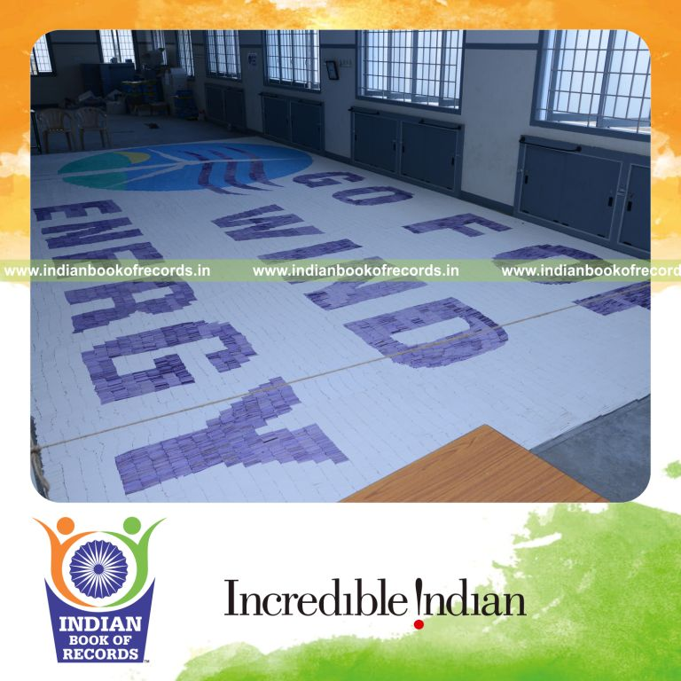 young boy creating mosaic using chalk pieces for Indian Book of Records