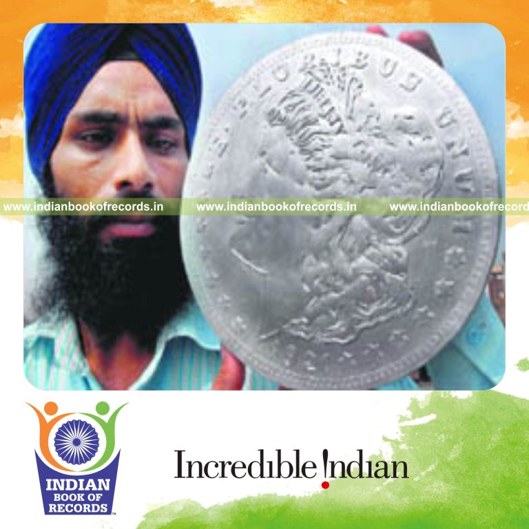 male individual creating large coin using papers for record in Indian Book of Records