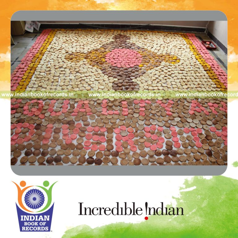 young female creating large cupcake mosaic artwork for record in Indian Book of Records