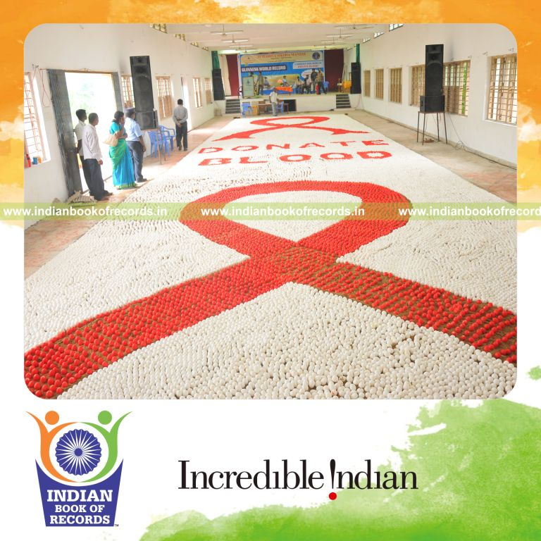 male individual creating large egg mosaic artwork for record in Indian Book of Records