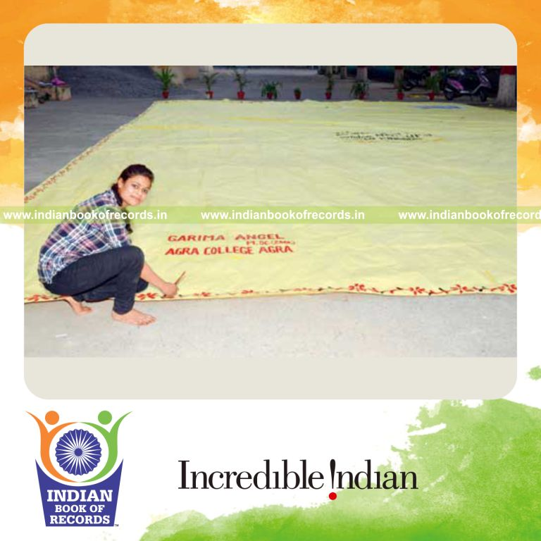 female individual creating large envelope for record in Indian Book of Records