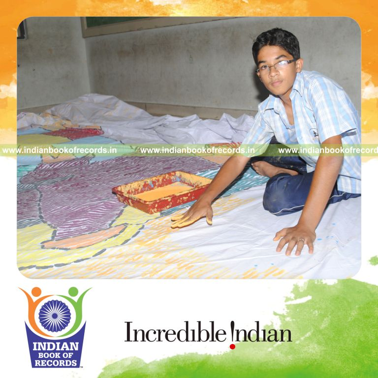 young male creating large finger painting for record in Indian Book of Records