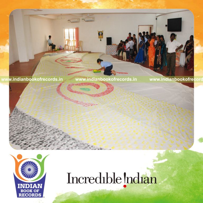 female individual creating large finger painting artwork for record in Indian Book of Records