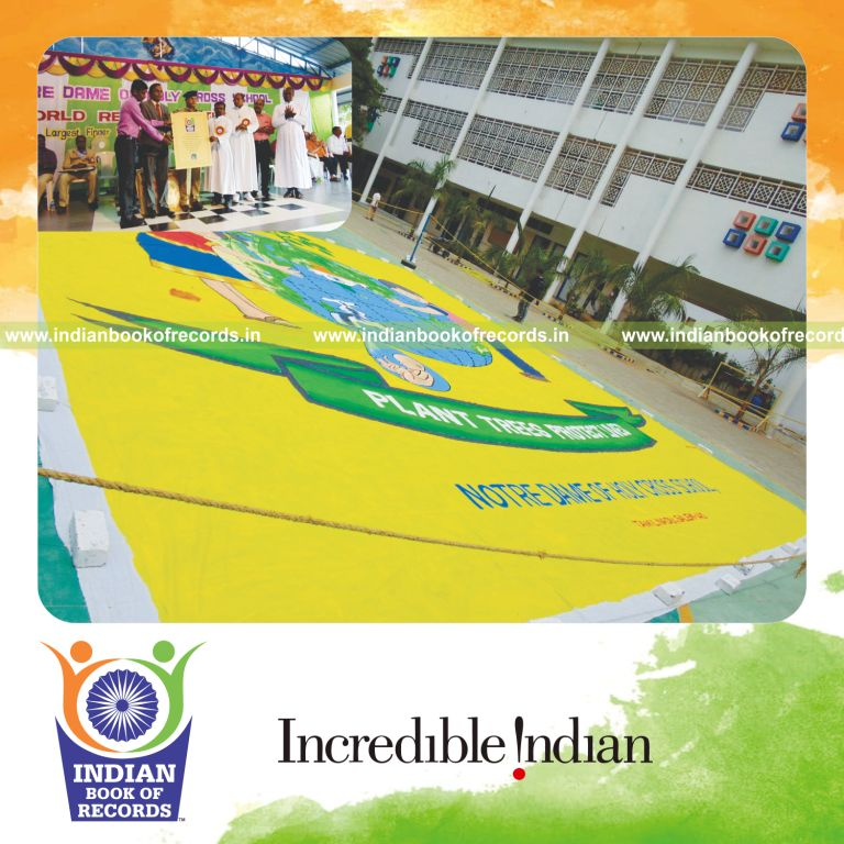 individual male creating large finger painting artwork for Indian Book of Records