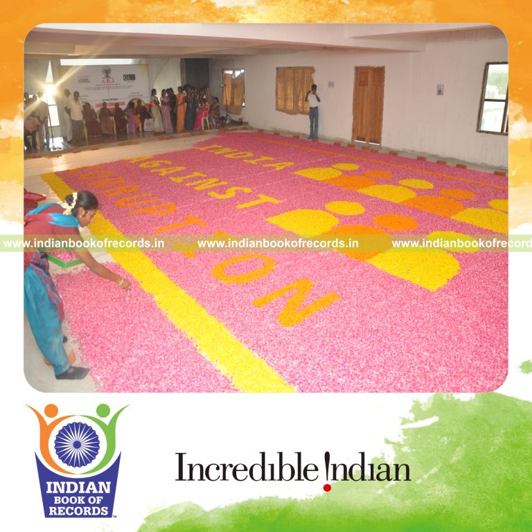 female individual creating large flower mosaic artwork for record in Indian Book of Records