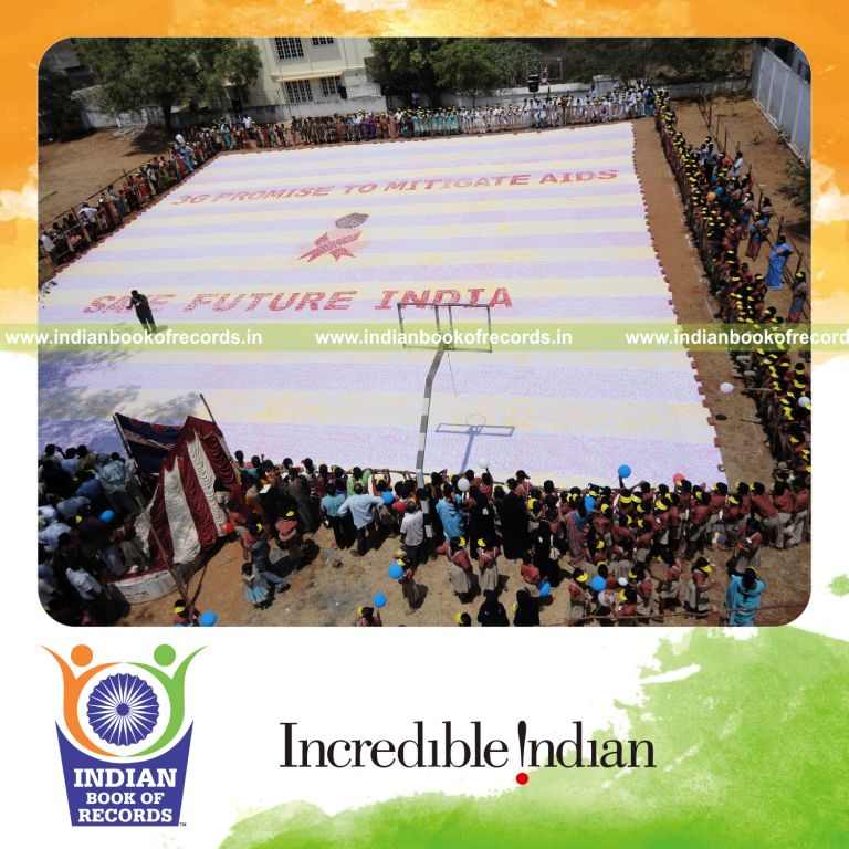 three generations creating a large footprint painting for record in Indian Book of Records