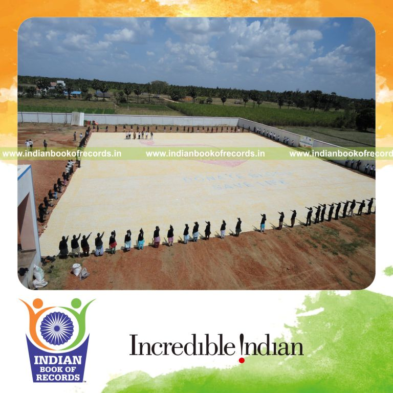 team creating large footprint painting for record in Indian Book of Records