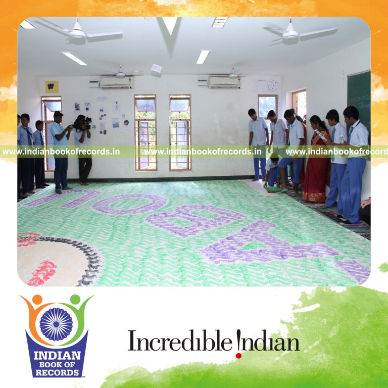 male individual creating large footprint painting for record in Indian Book of Records