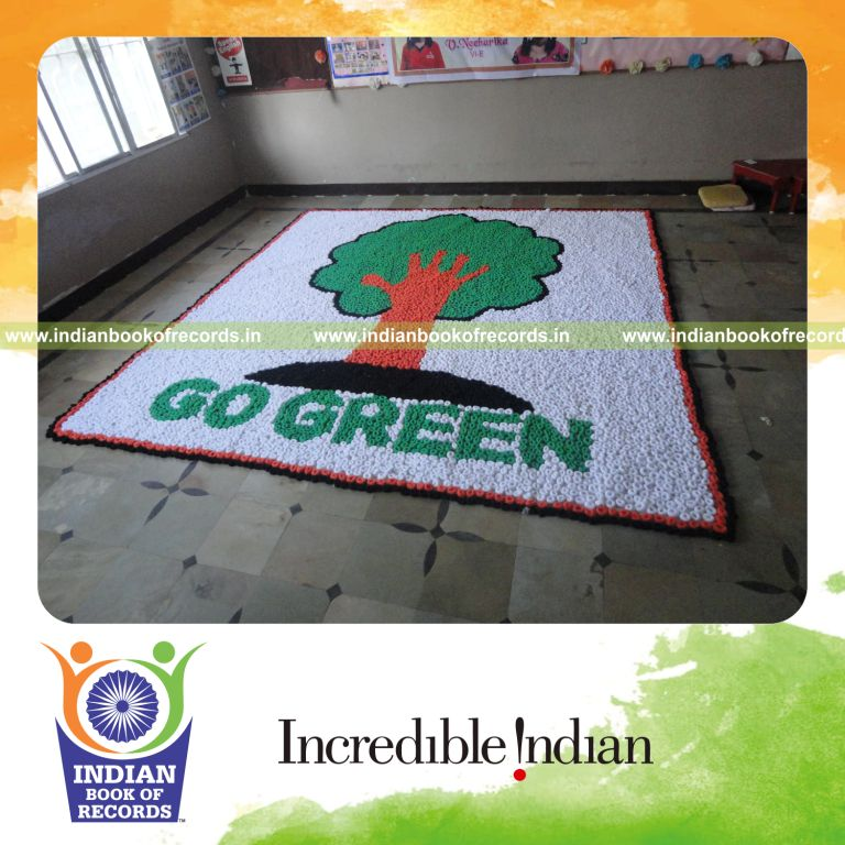 young female creating large mosaic using hair bands for record in Indian Book of Records