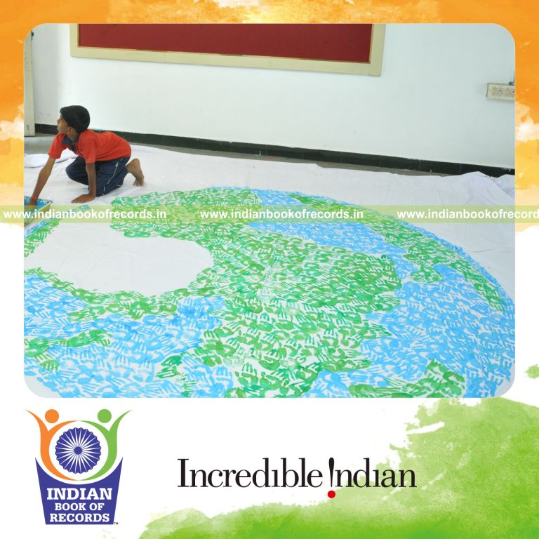 young male creating large handprint painting for record in Indian Book of Records