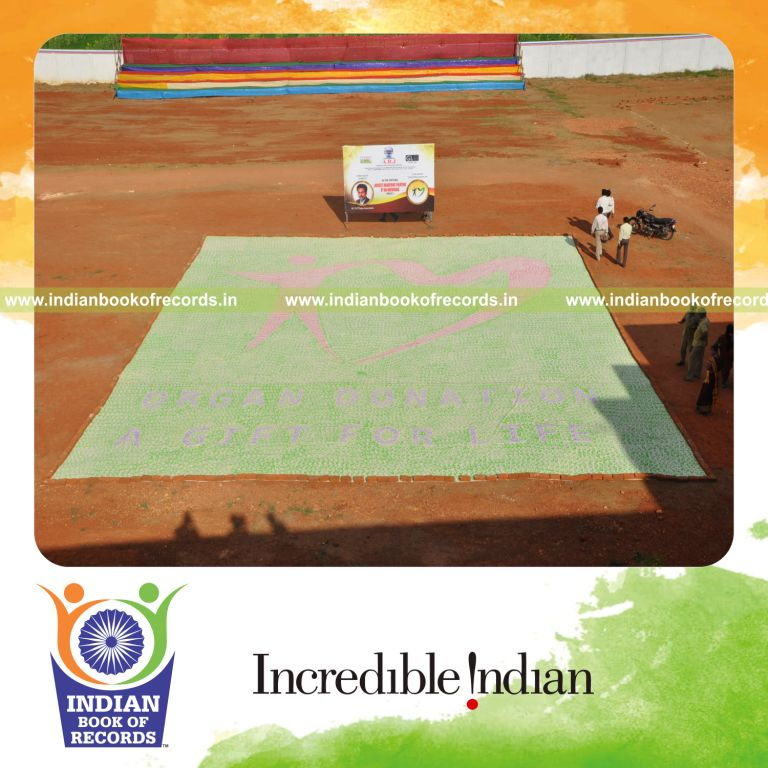 male individual creating large handprint painting for record in Indian Book of Records