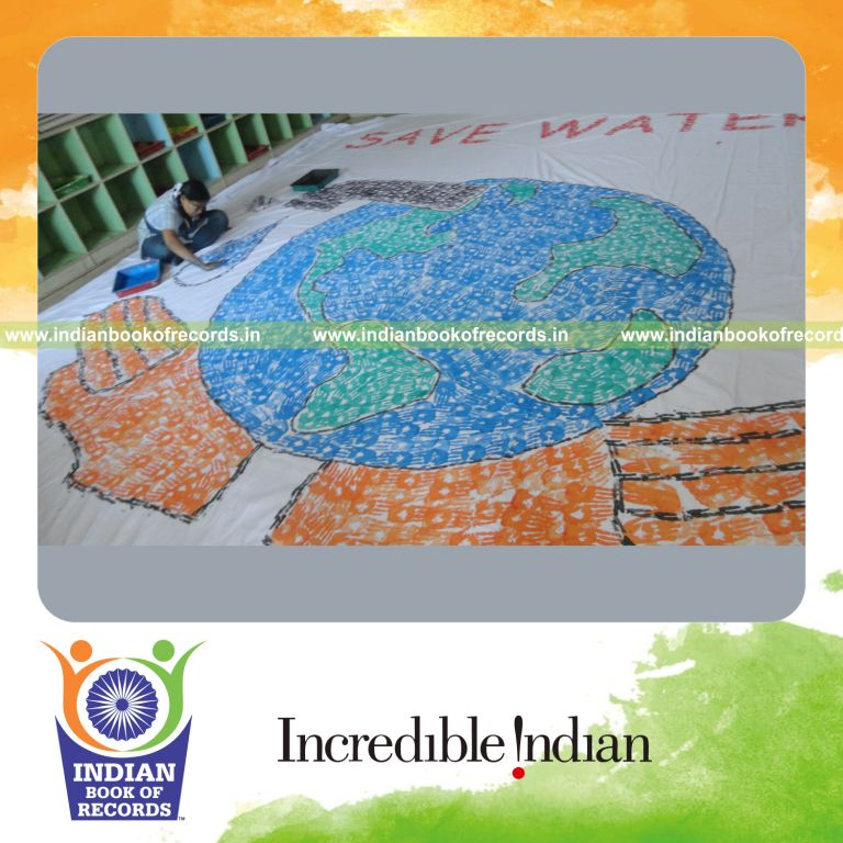 young female creating large handprint painting for record in Indian Book of Records